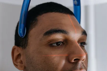 Patient undergoing a CBCT cone beam CT scan at a dental clinic in Turkey for implant planning