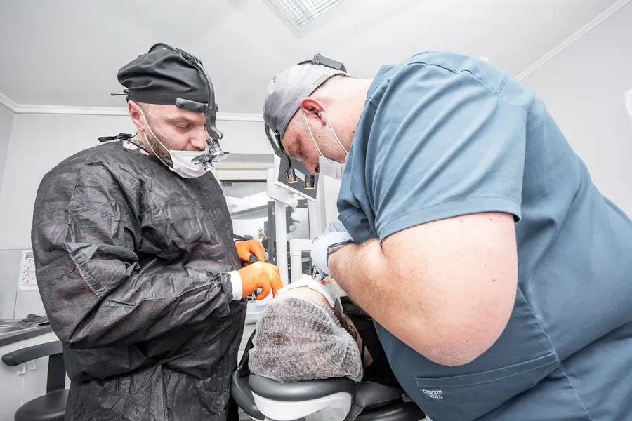 Two qualified dental surgery professionals at a specialist clinic, demonstrating the accredited team standards patients should look for when choosing treatment abroad
